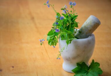 purple petaled flowers in mortar and pestle