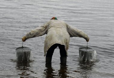 a person carrying buckets of water